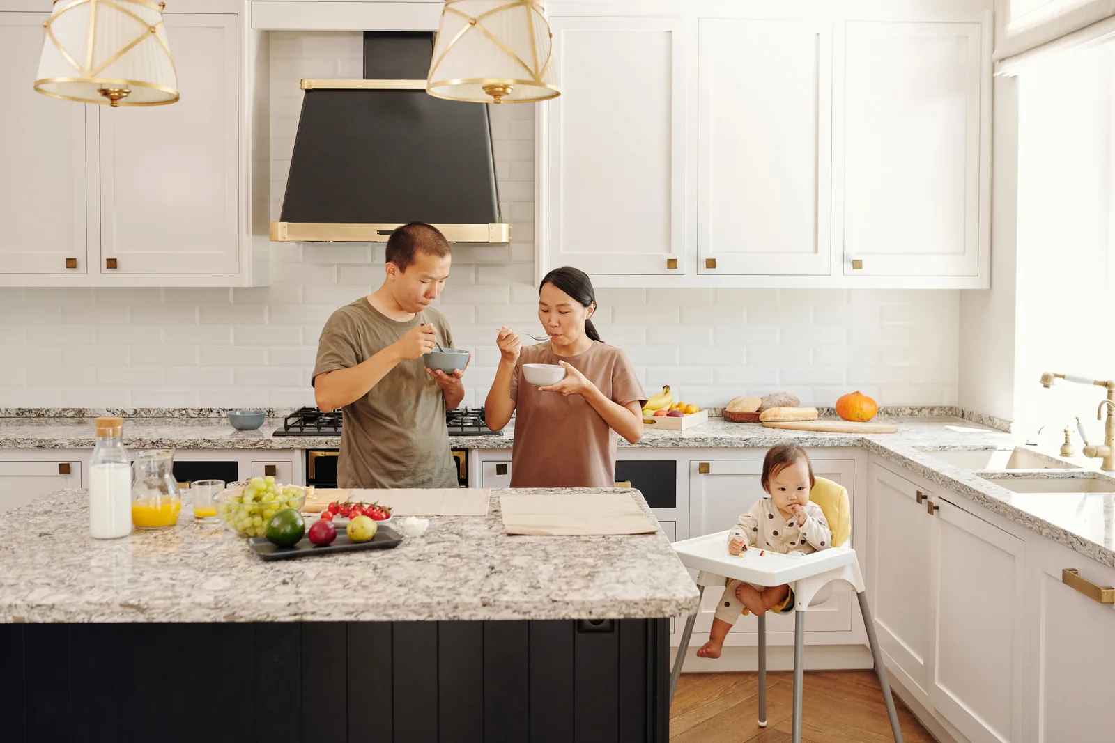 A young family preparing breakfast together in a bright kitchen